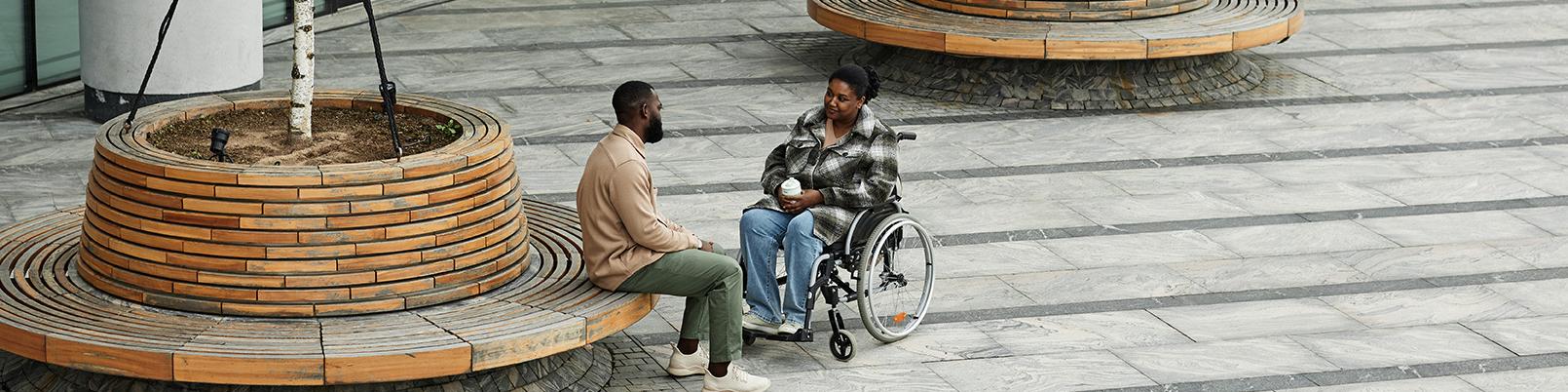 Man and woman talk in city's public space