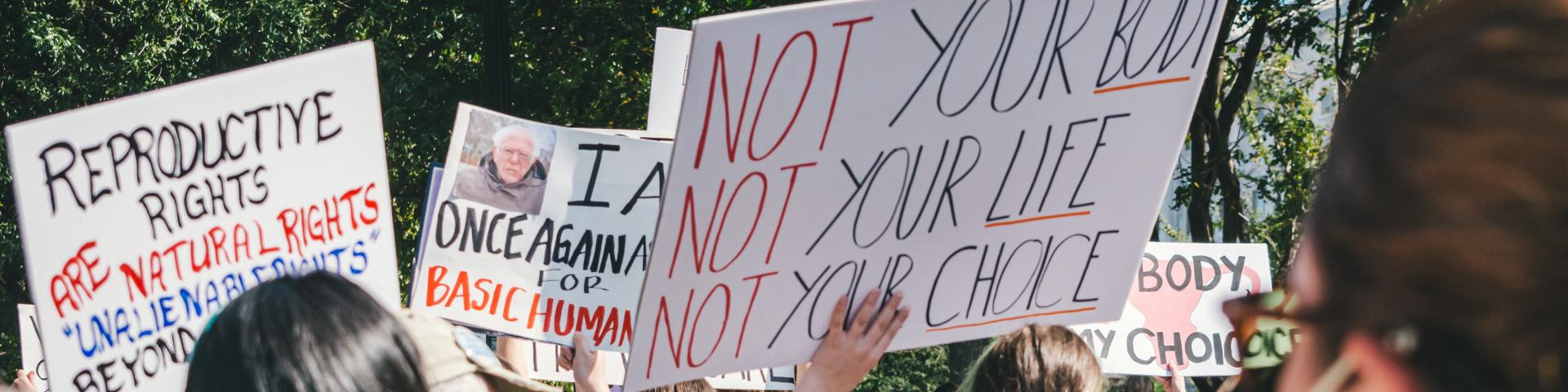 Women holding signs protesting for their abortion rights