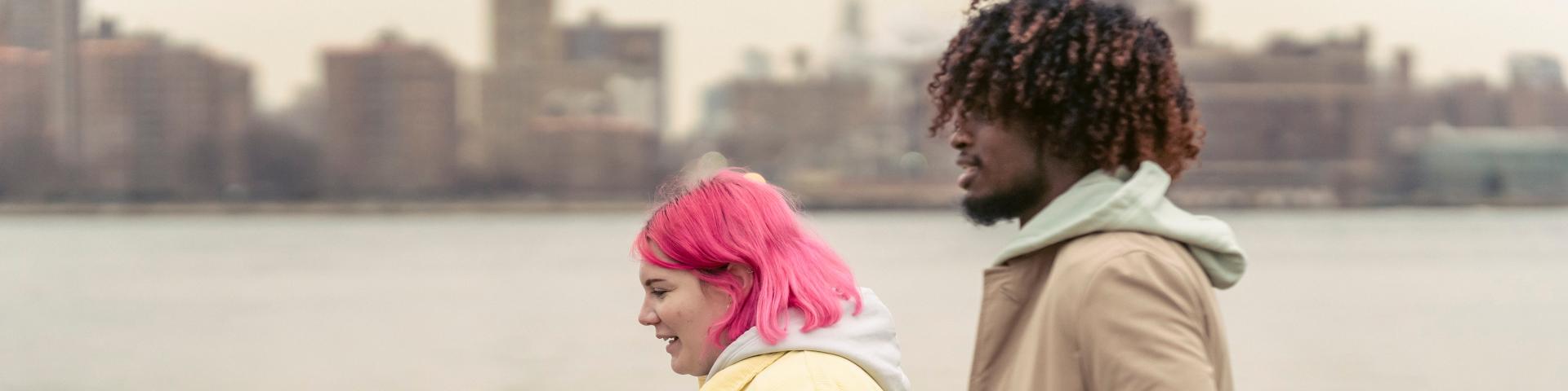 Two young people walking by the sea