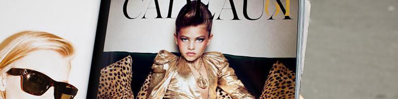 Hand holding a magazine showing an underage model 