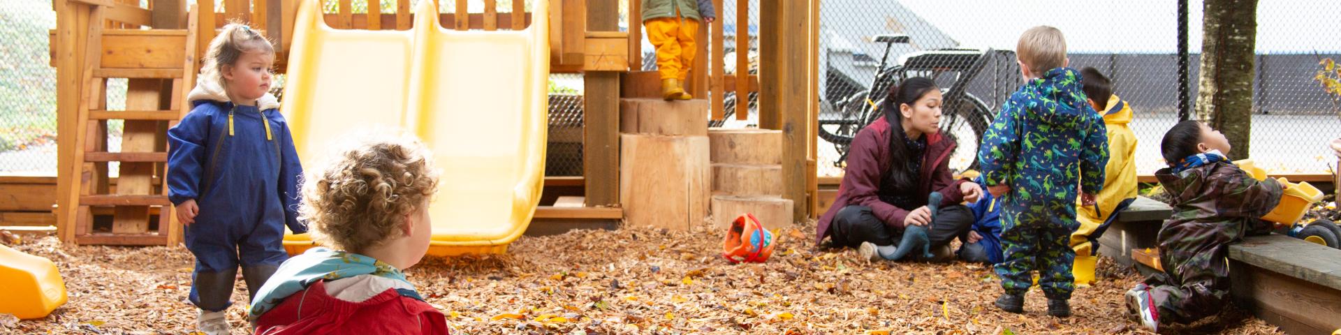 Care giver and children playing outdoors