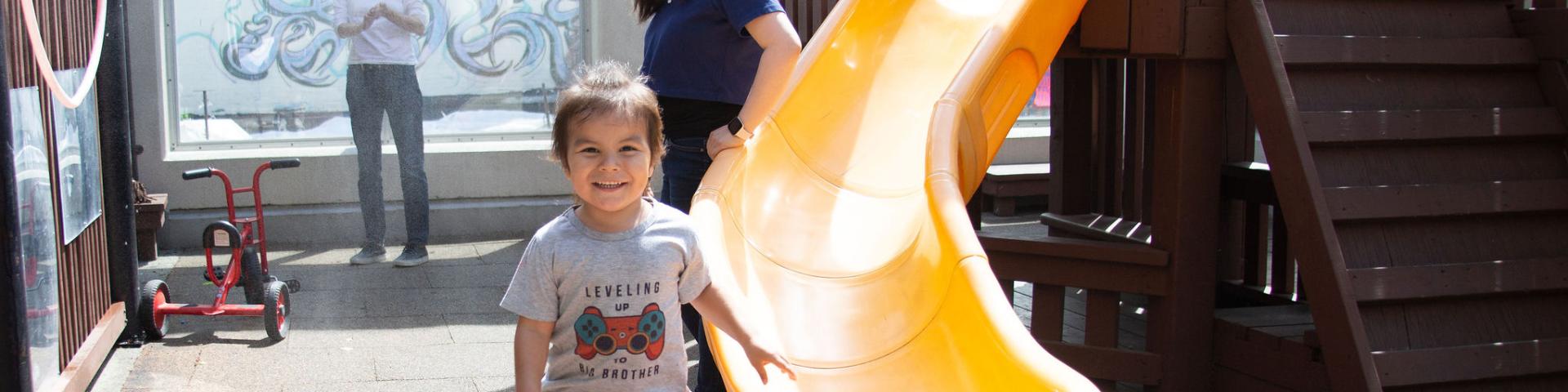 Toddle playing by the slides at YWCA Crabtree Corner Child Care