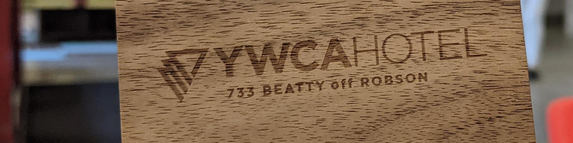A photo of a wooden keycard from YWCA Hotel - sustainability