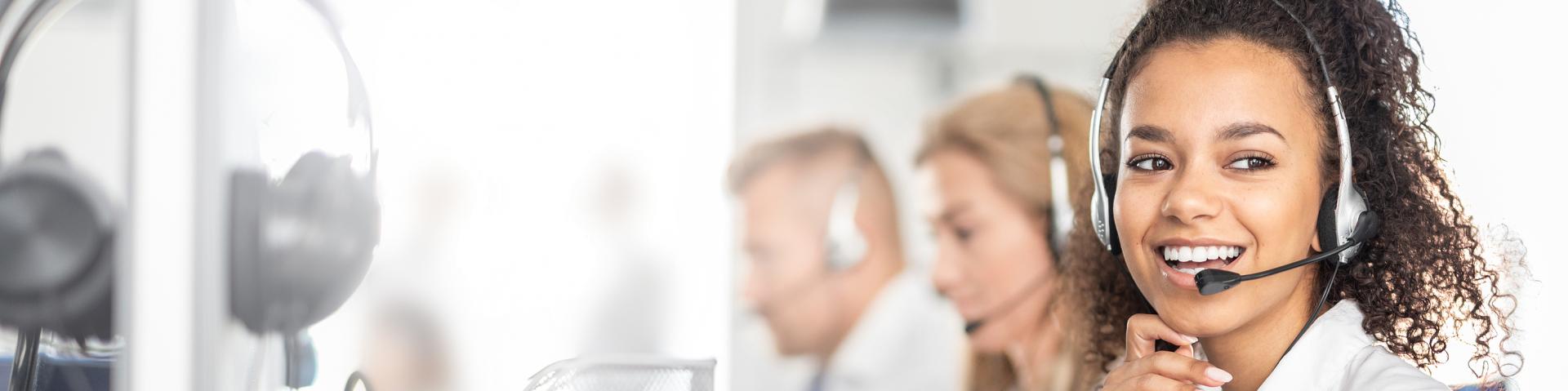 Call centre employee smiling on phone