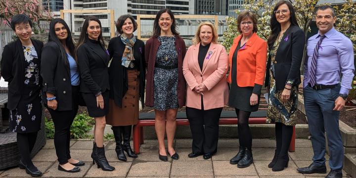 Axis program managers and facilitators stand with YWCA CEO and BC government ministers to celerb