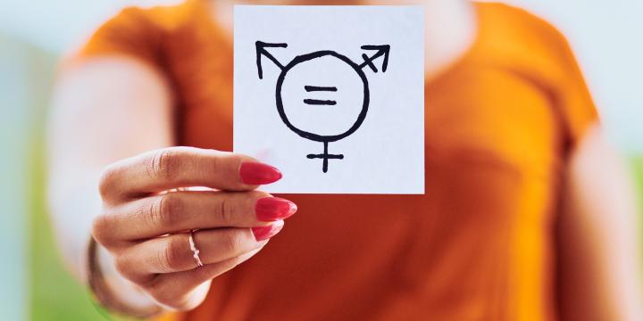 Person holding paper showing gender equality