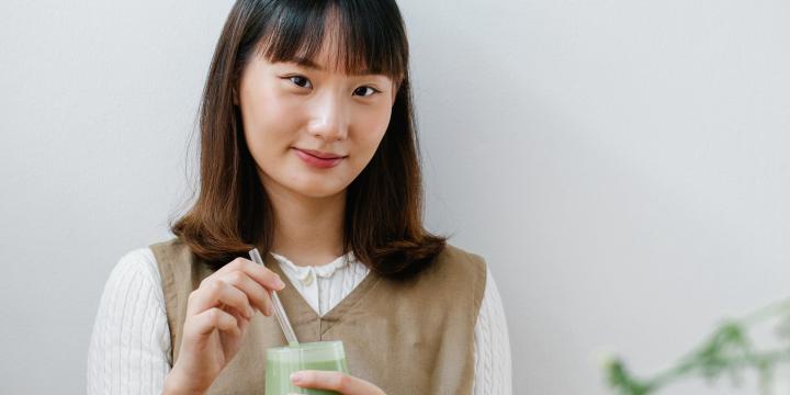Japanese woman holding a matcha drink