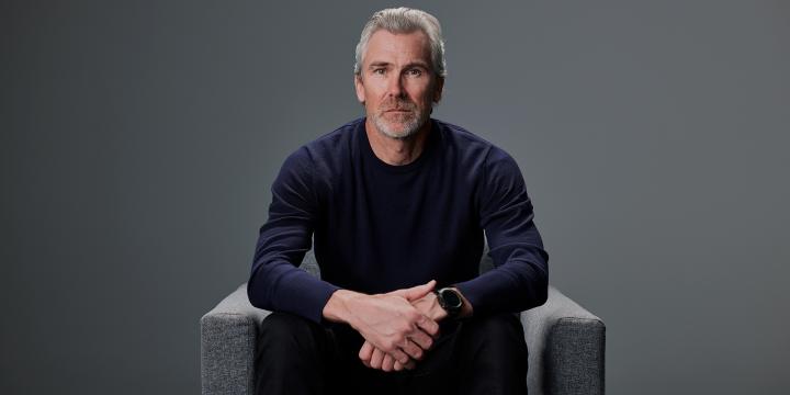 Trevor Linden seating on a chair with natural face expression