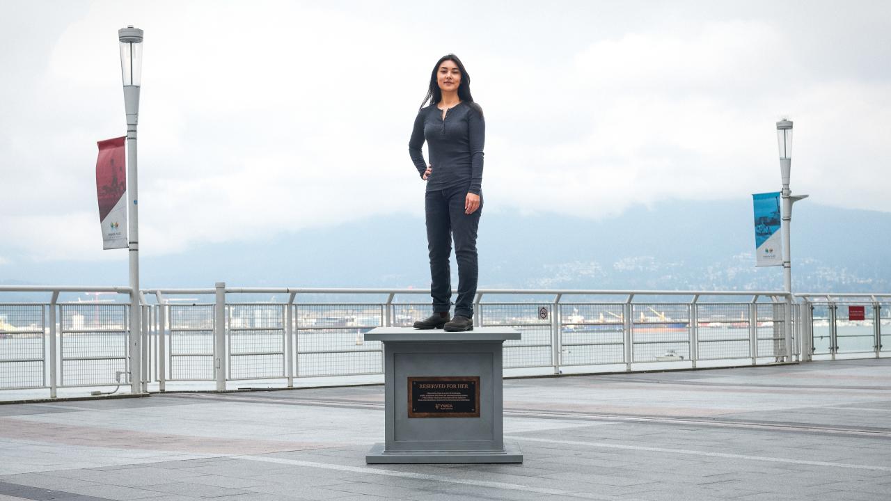 woman posing on statue base