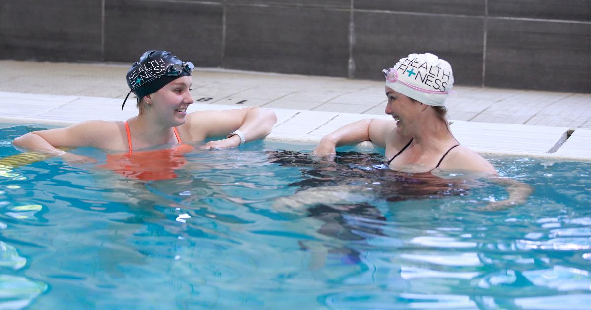 Instructor and student at the YWCA Health + Fitness Centre pool