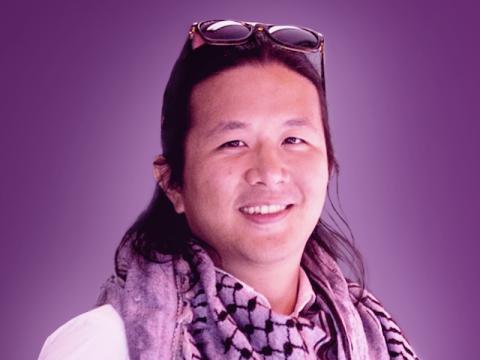 Photo of Kevin Huang on purple background