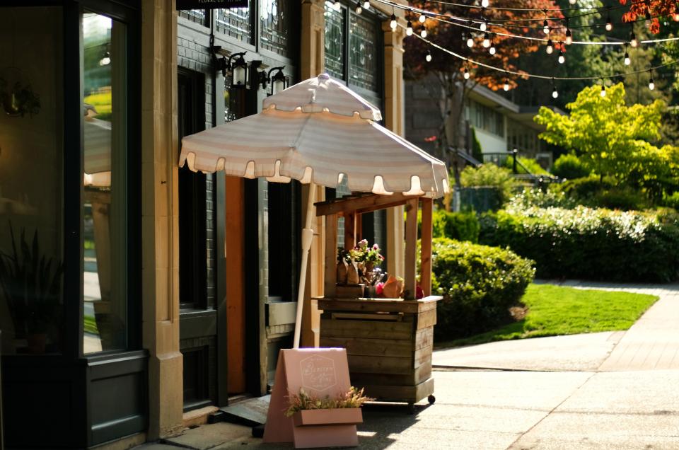 Umbrella and cafe lights in front of a cafe shop on the side of the street in Mount Pleasant