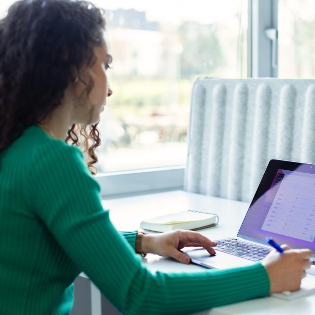 Employee woman taking notes on a project management software