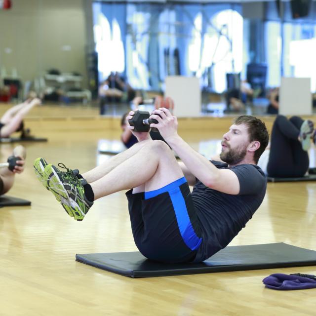 man doing crunches with weights 