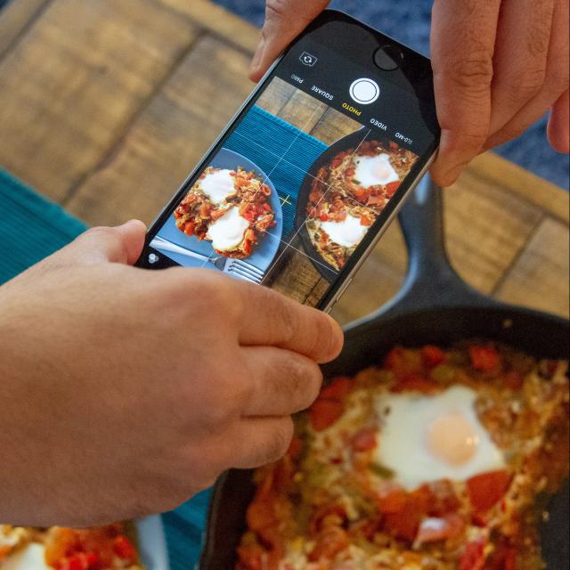 Photo of person taking picture of food
