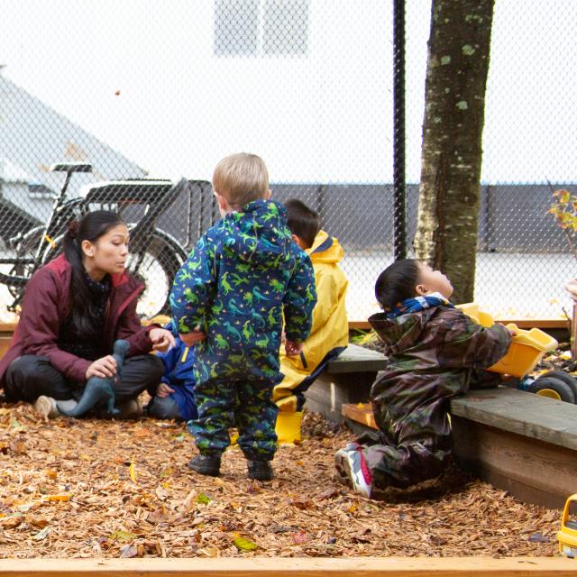 Care giver and children playing outdoors