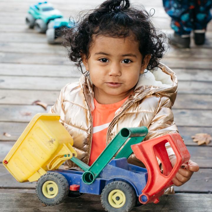 Girl playing with truck