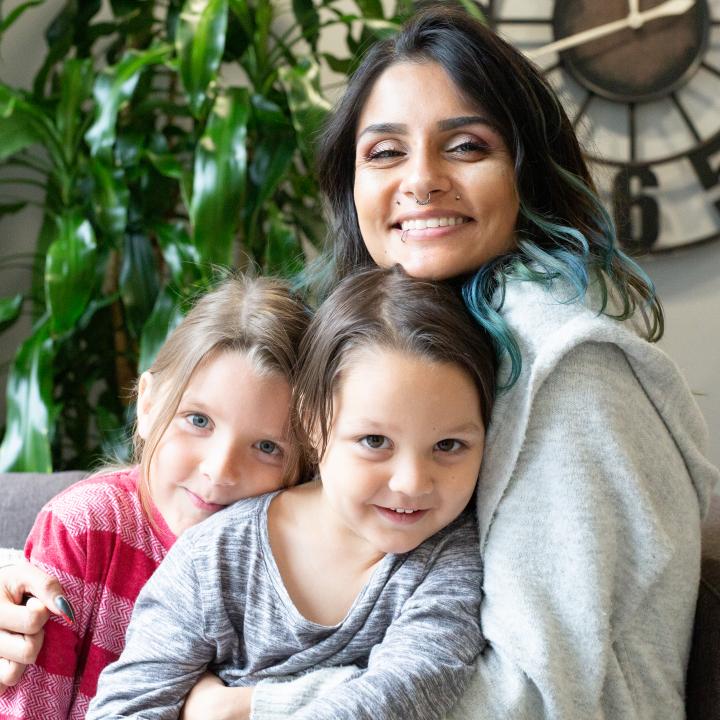 Mother and two daughters smiling