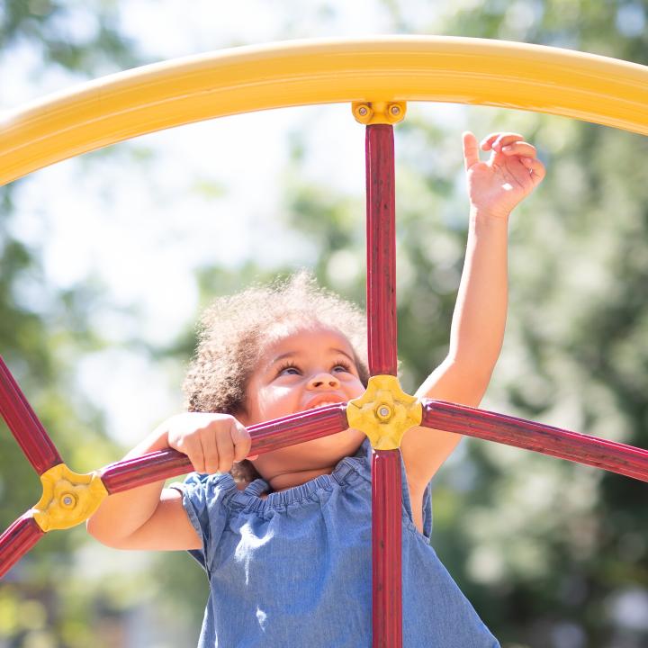 Young girl reaching high